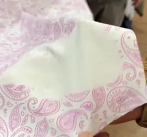 fabric's pattern fades as hand lifts